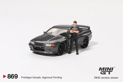 (Pre-Order) 1/64 Mini GT MGT00869-R Nissan Skyline GT-R (R32) Nismo Gunmetal RHD w/ Matsuda Figure